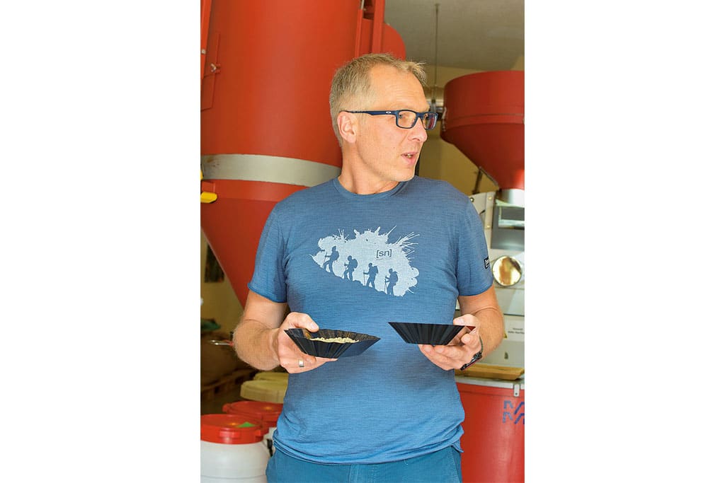 Redakteur mit zwei Schüsselchen voller Kaffeebohnen in den Händen