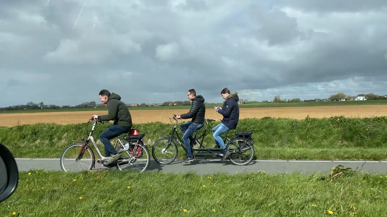 Eine Gruppe Radfahrer, die dem Wind trotzen.