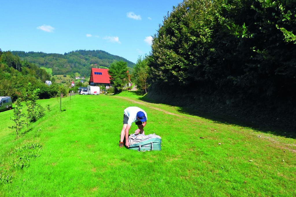 Mann beim Zeltaufbau